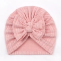 Close-up of pink knit baby turban hat featuring a large soft decorative bow - One Size / Snow Bud