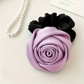 Detailed close-up of a satin light purple 3D rose flower on a black elastic scrunchie hair tie - Purple