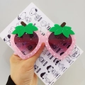 Pink strawberry shaped sunglasses for kids with white polka dots and green leaf detail - Pink