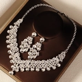 Detailed view of silver necklace and earrings set with crystal pearls on satin display - Silver Jewelry Set