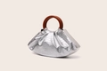 Detail of silver crocodile texture handbag with round wooden handle and pleated cloud design - Silver