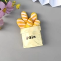 3D resin fridge magnet featuring baguette bread inside a yellow paper bag design - New Yellow Bread Bag
