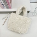 Detail of white sherpa fleece tote bag with a soft plush texture and woven brand label - Off-white