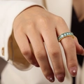 Elegant gold-plated ring featuring rectangular light blue zircons on a model's hand - Style C Light Blue