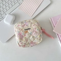 Detail of quilted sanitary pad storage pouch with floral patterns and pink cord zipper - Colorful Star Puppy