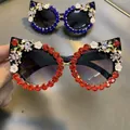 Cat eye sunglasses with red rhinestones and floral 3D details on a dark frame - Black Frame / Deep Red Rhinestone