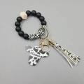 Detail of cow-print beaded keychain bracelet with Mama bull head charm and leather tassel - Black