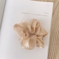 Elegant champagne satin scrunchie with silk luster finish on a white background - Pearly Satin Champagne