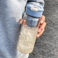 Morandi blue portable water bottle with tea infuser and ice cubes in a lifestyle hand-held shot - 650ml / Blue Lid
