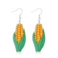 Detail view of creative yellow corn drop earrings with green husks and silver hooks - Corn