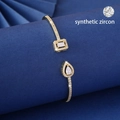 Elegant gold-plated open bangle featuring synthetic zircon in square and teardrop shapes - Gold White
