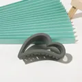 Detail view of heart-shaped dark grey hair claw clip with matte finish and non-slip teeth - Matte Heart - Dark Gray