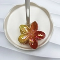 Glossy gradient plumeria hair claw clip in orange and yellow hues on a white tray - Yellow & Orange-Red AB