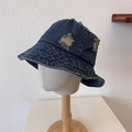 Deep blue distressed denim bucket hat with frayed edges on mannequin head display - One Size / Dark Blue