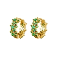Detailed macro view of gold-plated hoop earrings featuring emerald green zircon clusters - Green