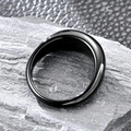 Macro close-up of polished black titanium water drop ring on grey stone texture - US 7 / Black