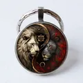 Yin Yang lion glass gem keychain with silver metal ring and artistic beast motif - Black and White Lion Yin Yang