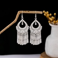 Silver Bohemian flower earrings with long metal tassels hanging on a branch - Bohemian Hollow Pattern Metal Tassel Style (E5823)