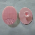 Pink oval silicone face cleansing brush with soft bristles and suction cup handle - Pink