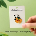 Cute panda enamel pin holding a persimmon, measuring 3cm by 2.8cm, fashion jewelry gift - Good Things Happen Panda