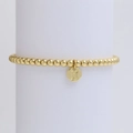 Close-up of golden beaded bracelet with a circular pendant featuring engraved letter X - Letter X (DB240603-X)