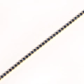 Detailed diagonal shot of a gold tennis bracelet featuring round-cut blue cubic zirconia - Royal Blue Zircon - Gold