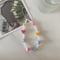 Close-up of beaded phone strap with white pearls, pink tulips, and acrylic butterfly charms - Flower Butterfly A1