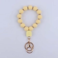 Detail of yellow silicone beaded keychain with U-shaped charm and gold metal ring clasp - Yellow