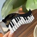 Pince à cheveux motif touches de piano avec note de musique dorée et paillettes - Piano à Vagues