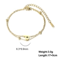Detail of gold double-layer stainless steel bracelet with letter P pendant and golden beads - Letter-P / Gold