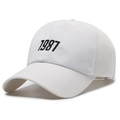 White baseball cap with black 1987 embroidery in minimalist six-panel cotton design - White