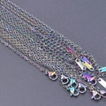 Close-up of rainbow plated stainless steel 1.6mm cross chains with S.STEEL tags - 1.5mm / Colorful