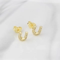 Elegant gold-plated U-shaped stud earrings with zircon inlay on marble background - Letter U