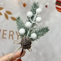Artificial Christmas pine needles with snowy red berries and a pinecone tied with a bow - White
