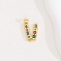 Macro shot of gold V-letter pendant featuring vibrant multi-colored inlaid gemstones - Letter V