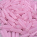 Close-up of bulk pink hexagonal double-pointed crystal pillars for DIY jewelry - Pink Jade