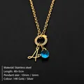 Gouden roestvrijstalen ketting met blauwe edelsteen en cursieve letter A hanger - Letter A / Goud