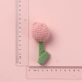 Handmade crochet pink tulip flower pendant in wool yarn shown with ruler for size - Pink Tulip Doll