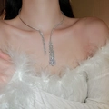 Close-up of a silver tassel necklace with rhinestones worn by a model in soft lighting - 15# Necklace-Silver (Full Diamond Tassel)