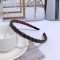 Detailed close-up of a black braided headband with delicate beaded pearl embellishments - Purple