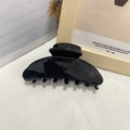 Glossy black acetate shark hair claw clip for women ponytail on minimalist background - Black