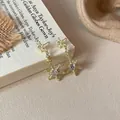 Elegant gold snowflake pendant earrings with white cubic zirconia in festive winter design - Gold Style