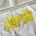 Detailed view of yellow star-shaped sunglasses with translucent resin frames and lenses - One-piece Star Yellow