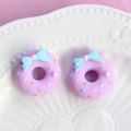 Macro view of purple resin donut charms with blue bows and colorful sprinkles for DIY - Small Bow - Purple Base + Blue