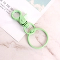 Light green painted metal lobster clasp with keychain ring on marble surface - Light Green