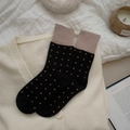 Detail of black mid-calf socks with brown polka dots and contrast nude pink ribbed cuffs - Black