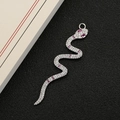 Ciondolo a forma di serpente argento con zirconi bianchi e pietre rosse su fondo nero - Argento