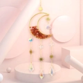 Detail of moon-shaped sun catcher with orange crystals and radiant crystal pendants - Red Agate Style