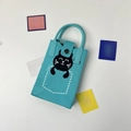 Detailed view of light blue knitted phone bag with a cute black cat pattern and magnetic closure - Sleeping Cat Blue