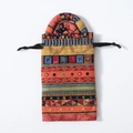 Detailed view of an ethnic pattern fabric drawstring bag with handles for dreadlock bands - Hair Tie & Bag Set / Ethnic Red